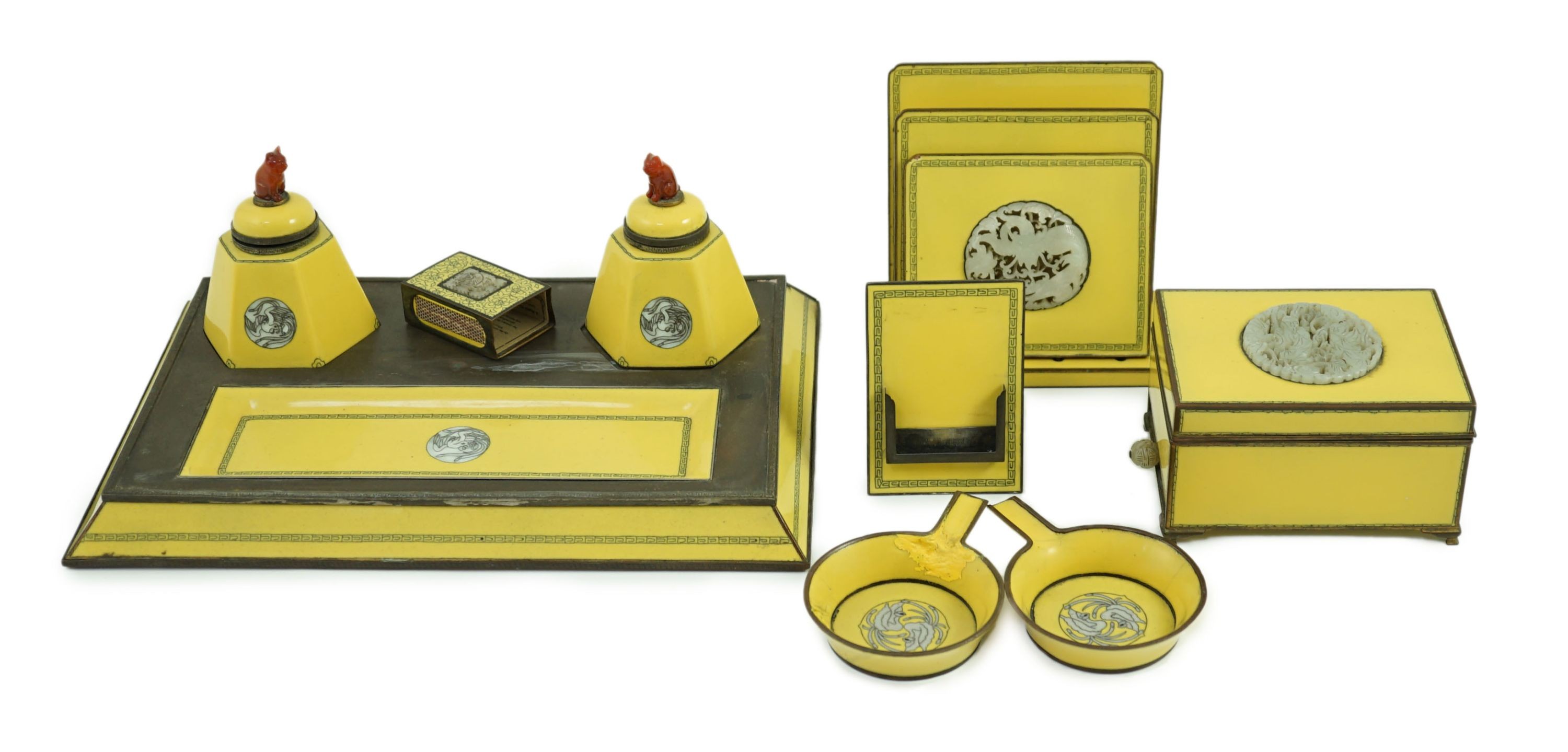 A Japanese cloisonné enamel desk set, 1920s, mounted with two Chinese Qing dynasty pale celadon jade plaques, retailed by Yamanaka & Co., Inkstand 31cm wide